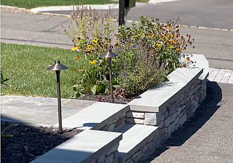 Stone retaining wall, garden bed with flowers and path lighting. Residential landscaping near me| Down To Earth Landscaping | Jackson New Jersey, USA (732) 833-7702