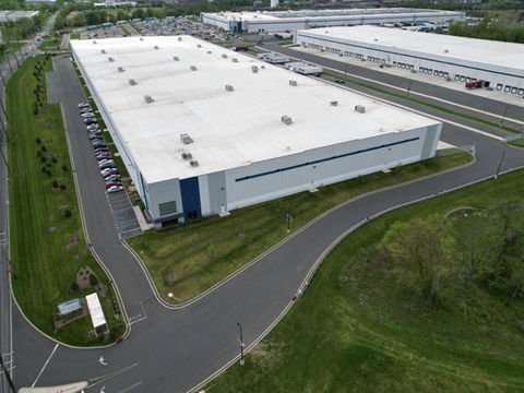 Aerial view of large white distribution warehouse building and parking. | Down To Earth Landscaping | Jackson New Jersey, USA (732) 833-7702