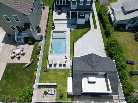 Aerial view modern house, swimming pool, patio, and landscaped backyard. | Down To Earth Landscaping | Jackson New Jersey, USA (732) 833-7702