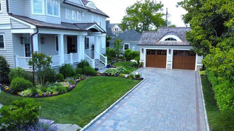Light grey house, landscaped lawn, paved driveway, detached two-car garage. Residential landscaping near me| Down To Earth Landscaping | Jackson New Jersey, USA (732) 833-7702