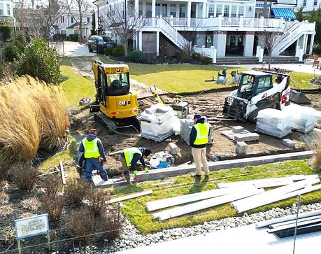 Construction workers with machinery preparing a residential landscape for installation. | Down To Earth Landscaping | Jackson New Jersey, USA (732) 833-7702